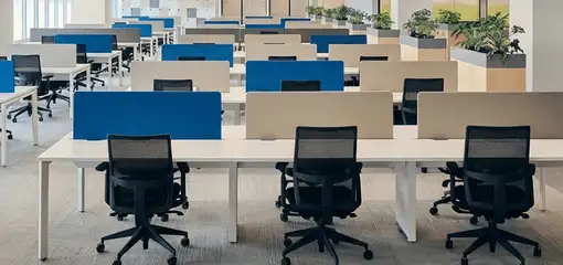 Modern open-plan office space featuring clean workstations, ergonomic chairs, and sanitized carpets provided by professional office cleaning services in Fort Worth, TX.