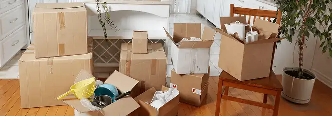 Packed moving boxes and household items in a kitchen before move-out or move-in cleaning, Fort Worth, TX.